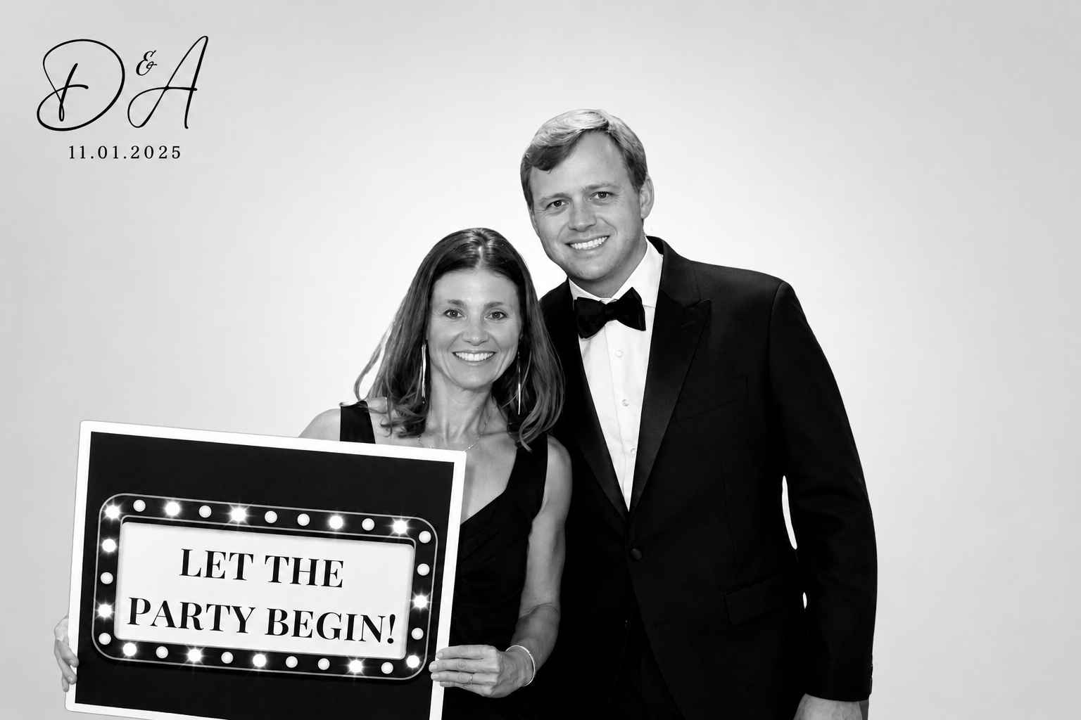 Wedding guests enjoying The Social Hub Nola’s luxury photo booth experience with a custom “Let the Party Begin” sign.